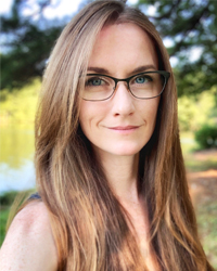 Dr. Kelly standing outside at a park