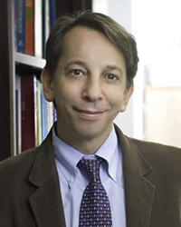 Dr. Klin standing in front of a bookcase